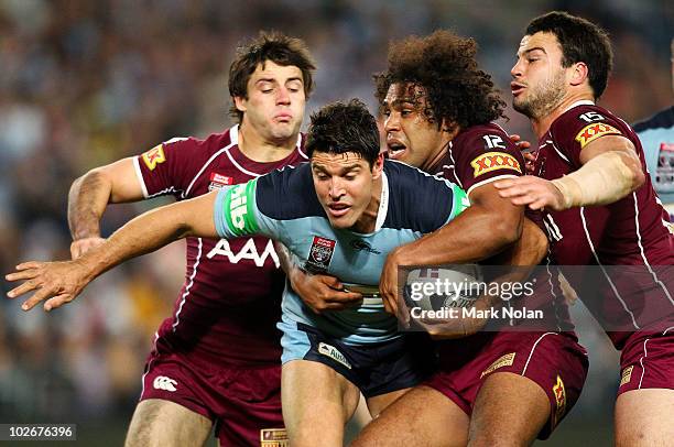 Trent Barrett of the Blues is tackled during game three of the ARL State of Origin series between the New South Wales Blues and the Queensland...