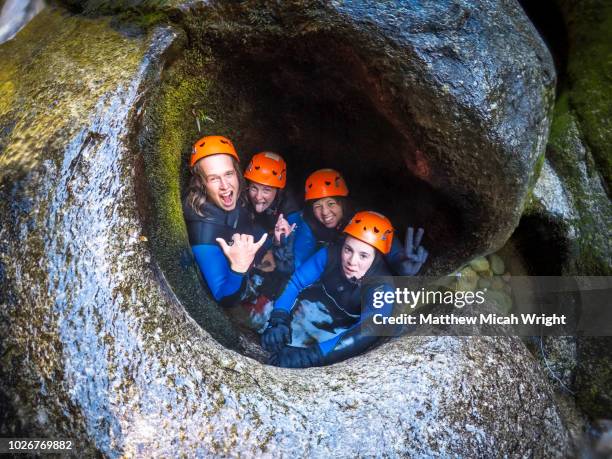 canyoning is one of the exciting adventure activities in the able tasman national park. you see remote parts of the park that cannot be reached any other way as you abseil, slide, swim, float, dive, and jump down the rivers and waterfalls. - new zealand national team bildbanksfoton och bilder