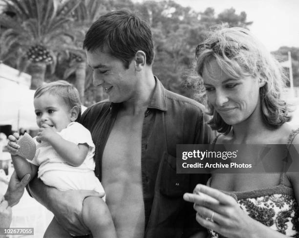 French actor Alain Delon with his wife Nathalie and their son Anthony on the beach at Monte Carlo, 15th August 1965.