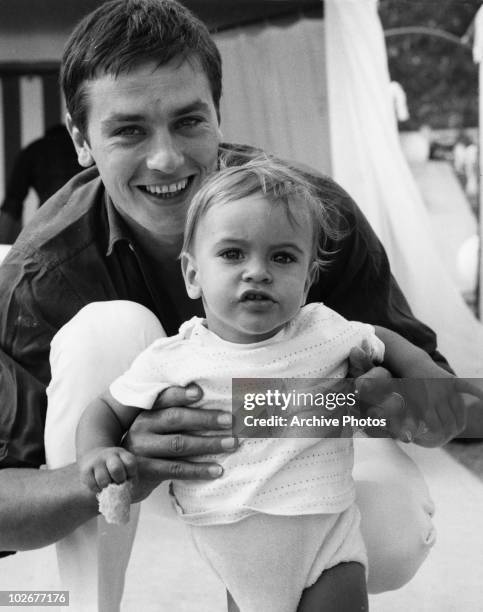 French actor Alain Delon with his son Anthony on the beach at Monte Carlo, 15th August 1965.