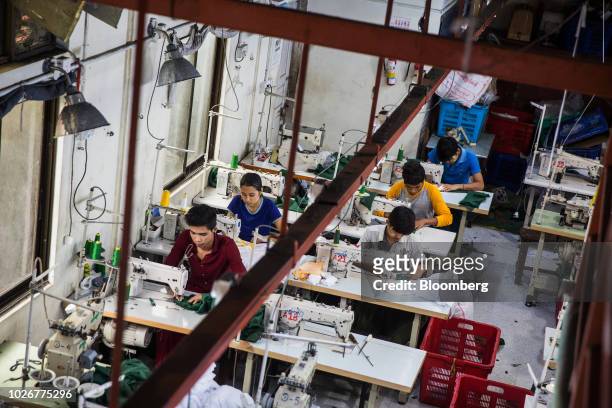 Workers use sewing machines to manufacture shirts at the Kaung Aunt Garment Manufacturing Co. Factory in Yangon, Myanmar, on Friday, Aug 31, 2018....
