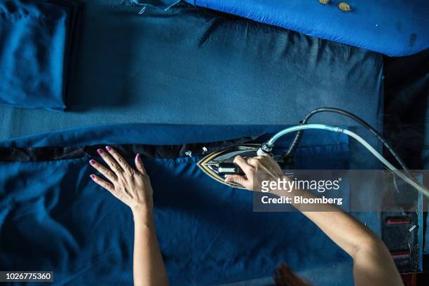Worker irons a piece of clothing at the Kaung Aunt Garment Manufacturing Co. Factory in Yangon, Myanmar, on Friday, Aug 31, 2018. Southeast Asia can...