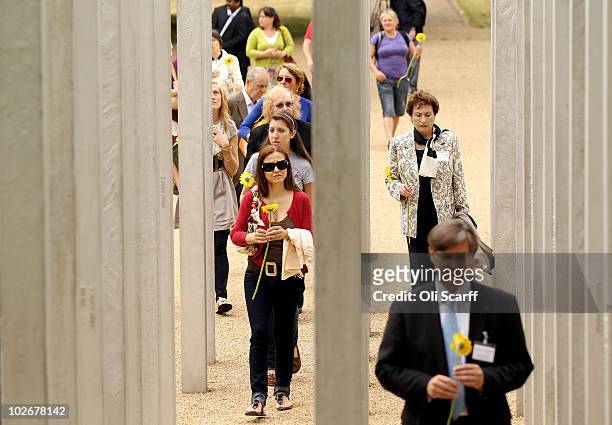 Mourners lay yellow flowers at the memorial to the victims of the July 7, 2005 London bombings in Hyde Park on July 7, 2010 in London, England. Today...