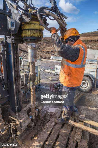 drilling worker examining drilling rig - geology tools stock pictures, royalty-free photos & images