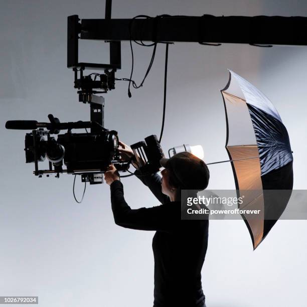 camerawoman behind the scenes on a film set - movie crew stock pictures, royalty-free photos & images