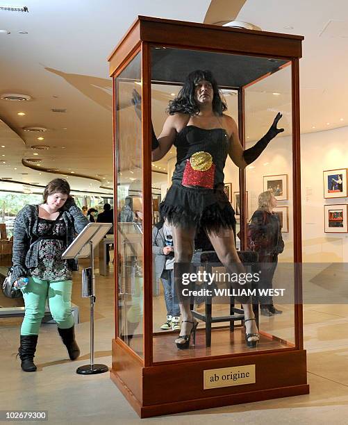 Constantina Bush, an alter-ego of male Aboriginal performer Kamahi King, poses in a museum display case in 'Jacky Jacky in the Box' at a preview of a...