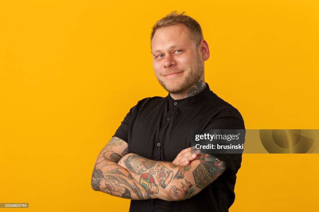 Studio portrait of a hairdresser on a yellow background