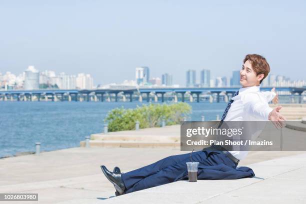 a male office worker at a park - yeouido stock pictures, royalty-free photos & images