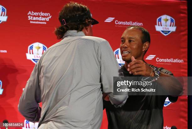 Tiger Woods hugs Phil Mickelson after being introduced along with Bryson DeChambeau by U.S. Ryder Cup Team Captain Jim Furyk, as his Captains Picks...