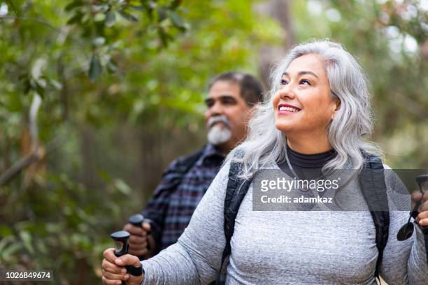 senior mexican couple hiking - mature adult hiking stock pictures, royalty-free photos & images