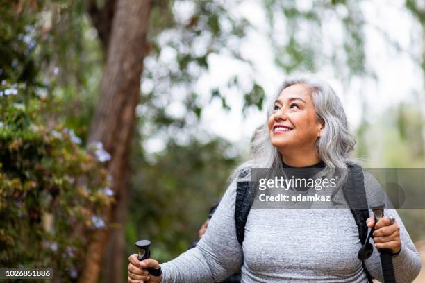 senior mexican couple hiking - hiking woman stock pictures, royalty-free photos & images