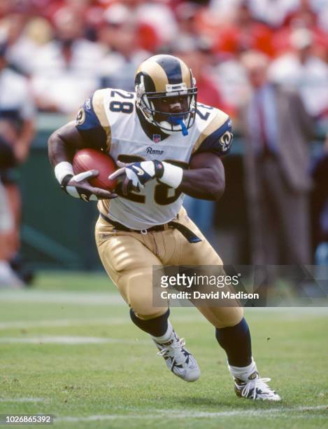 Marshall Faulk of the St. Louis Rams carries the ball in a National Football League game against the San Francisco 49ers on September 23, 2001 at...