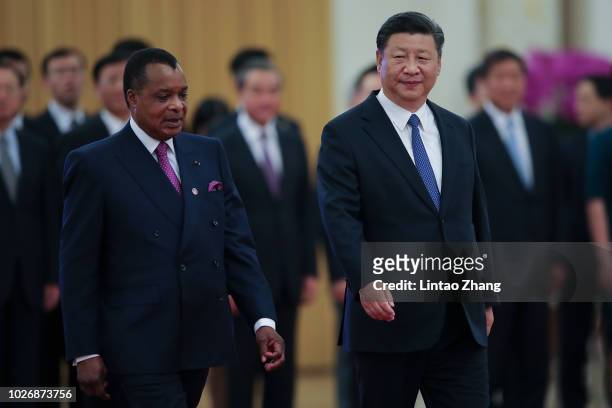Chinese President Xi Jinping invites Congo President Denis Sassou Nguesso to view an honour guard during a welcoming ceremony inside the Great Hall...