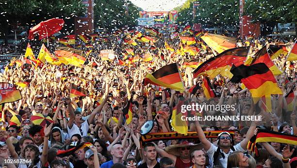 Thousands of fans of the German national football team cheer during the public viewing at the "Fanmeile" in Berlin on July 7 of the FIFA World Cup...