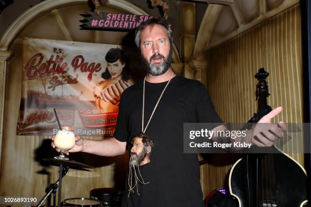 Comedian/actor Tom Green poses with a sculpture of a shrunken head in his likeness that was created for the bar's cabinet of curiosities after an...