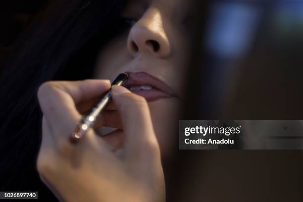 Photo shows the close-up portrait of a woman applying lip liner at a make-up and cosmetic products shop in Ankara, Turkey on September 04, 2018.