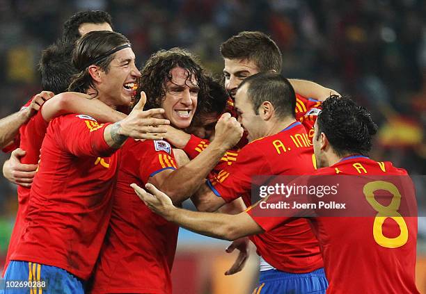 Spain team mates celebrate the opening goal scored by Carles Puyol during the 2010 FIFA World Cup South Africa Semi Final match between Germany and...