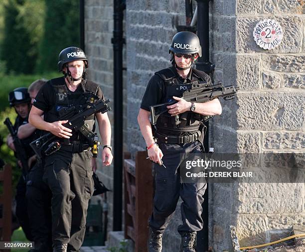 Armed police raid a cottage on the outskirts of Rothbury in the continued search for Raoul Moat, in Rothbury, northeast England on July 7, 2010....