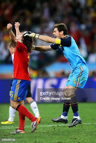 Iker Casillas of Spain celebrates with team mate Carles Puyol after victory and progress to the final during the 2010 FIFA World Cup South Africa...