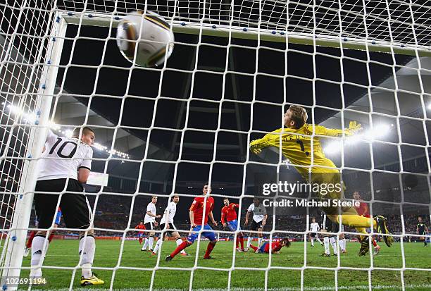 Carles Puyol of Spain scores the opening goal past Manuel Neuer of Germany during the 2010 FIFA World Cup South Africa Semi Final match between...