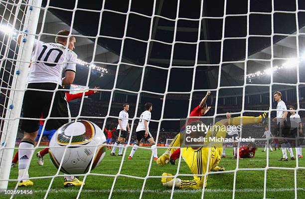 Carles Puyol of Spain scores the opening goal past Manuel Neuer of Germany during the 2010 FIFA World Cup South Africa Semi Final match between...