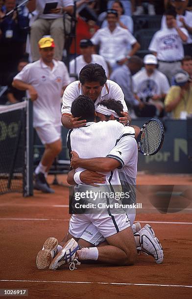 Alex Corretja and Juan Balcells of Spain are congratulated by Captain Javier Duarte of Spain on taking a 3-0 lead during the Davis Cup Semi-Final...