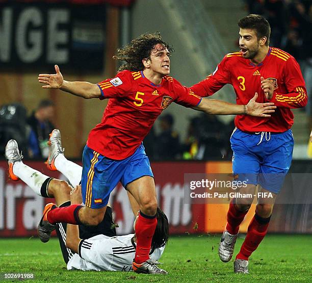 Carles Puyol of Spain celebrates with teammate Gerard Pique after scoring the opening goal during the 2010 FIFA World Cup South Africa Semi Final...