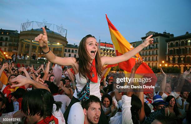 Spanish fans celebrate during the San Fermin running of the bulls' fiesta while watching Spain play Germany in the FIFA 2010 World Cup match on a...