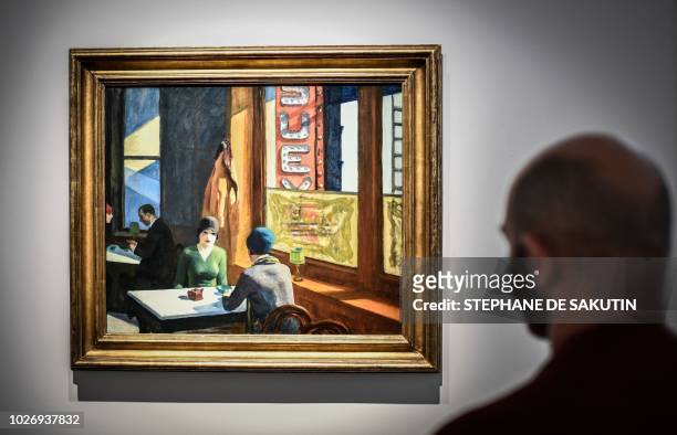 Man looks at a painting by US artist Edward Hopper named "Chop Suey", that is part of the Barney A Ebsworth Collection, during a presentation of the...