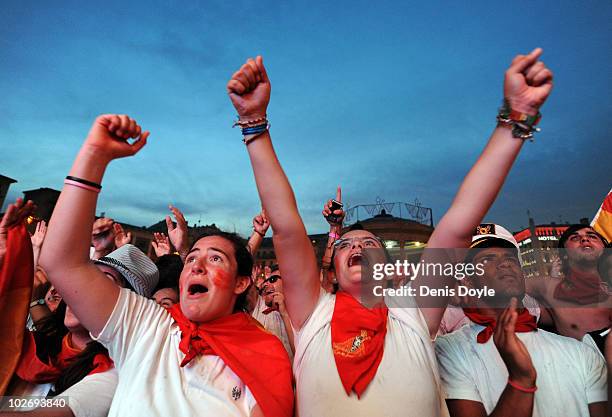 Spanish fans celebrate during the San Fermin running of the bulls' fiesta while watching Spain play Germany in the FIFA 2010 World Cup match on a...