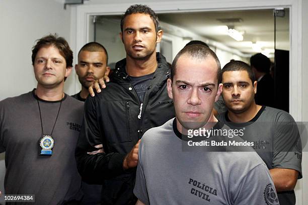 Flamengo goalkeeper Bruno Fernandes is guarded by officers as he turns himself in to the police at the Polinter station of Andarai Neighborhood on...