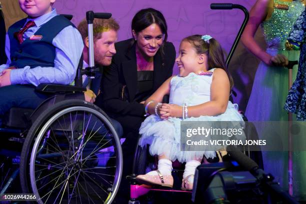 Britain's Prince Harry, Duke of Sussex, and his wife Meghan, Duchess of Sussex meet Matilda Booth, winner of the Inspirational Child award, during...