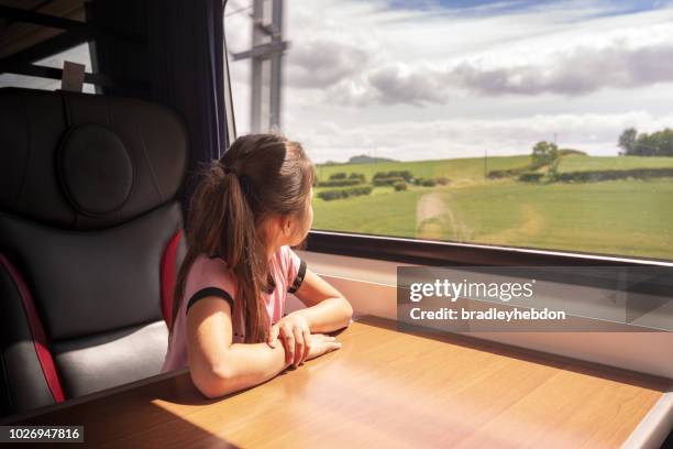 eurasian girl enjoying traveling by train in yorkshire, uk - luxury girl stock pictures, royalty-free photos & images