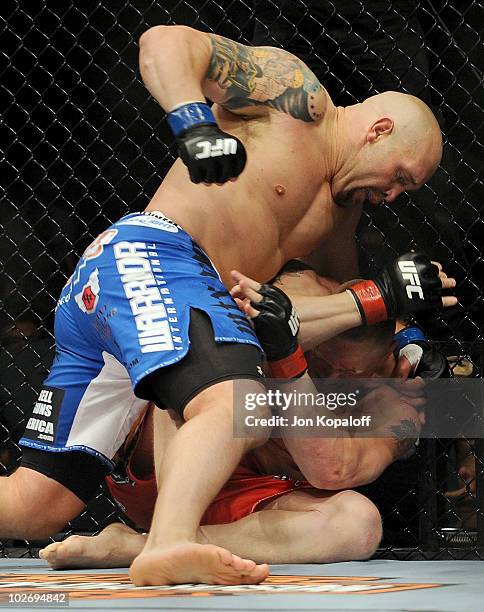 Shane Carwin holds down Brock Lesnar in the first round during the UFC Heavyweight Championship Unification bout at the MGM Grand Garden Arena on...
