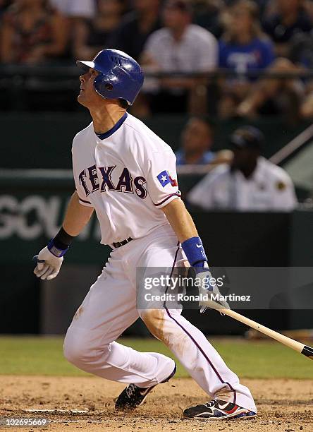 Michael Young of the Texas Rangers watches after hitting a two run home run against the Cleveland Indians on July 7, 2010 at Rangers Ballpark in...