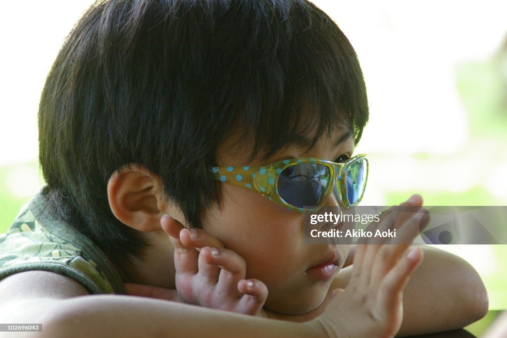 A boy with dark glasses