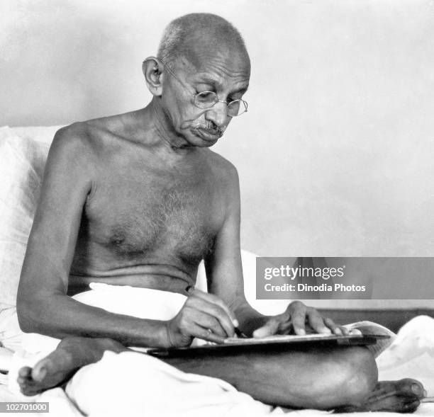 Indian statesman and activist Mohandas Karamchand Gandhi writing at Birla House, Mumbai, August 1942.