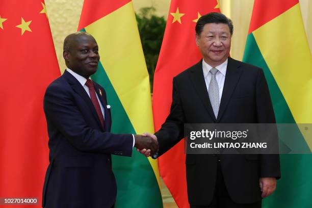 Chinese President Xi Jinping shakes hands with Guinea Bissau President Jose Mario Vaz at a meeting at the Great Hall of the People in Beijing on...