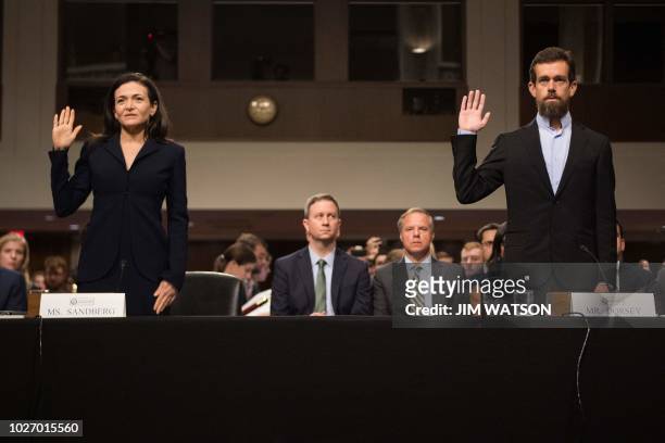 Of Twitter Jack Dorsey and Facebook COO Sheryl Sandberg are sworn in to testify before the Senate Intelligence Committee on Capitol Hill in...