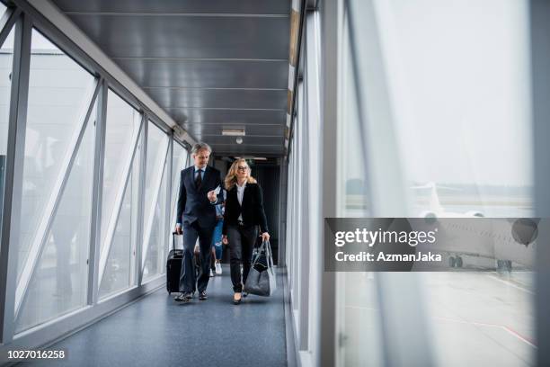 group of people boarding a plane - business air travel stock pictures, royalty-free photos & images