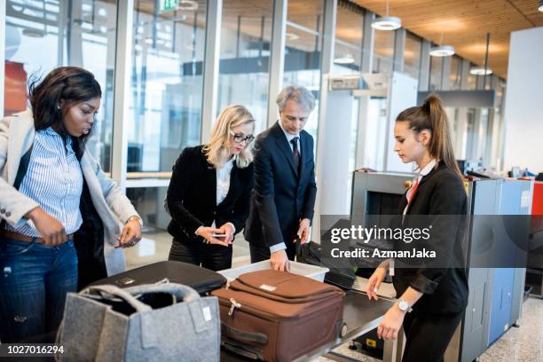 people passing security check on the airport - row police stock pictures, royalty-free photos & images