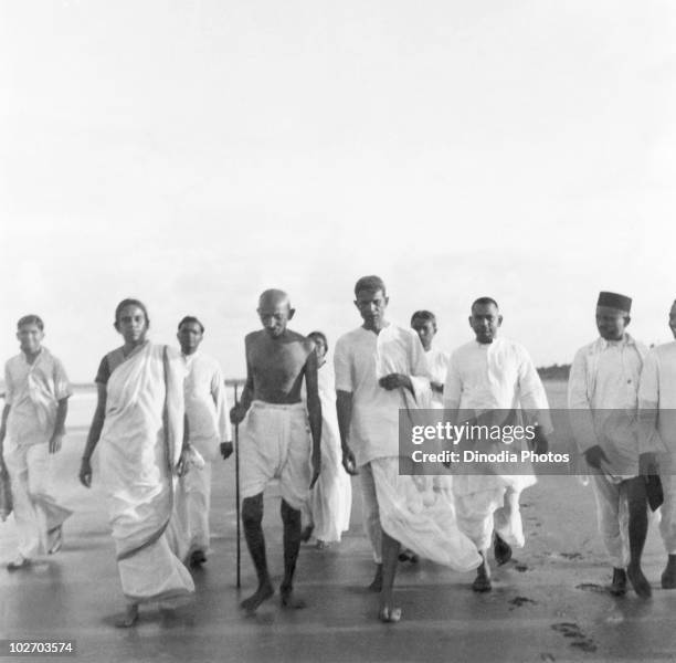 Indian statesman and activist Mohandas Karamchand Gandhi walking on Juhu Beach, Mumbai, May 1944.