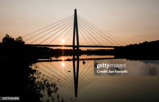 The sun rises behind the new Northern Spire bridge spanning the River Wear on the day that it opens for a pedestrian walk-over on August 28, 2018 in...