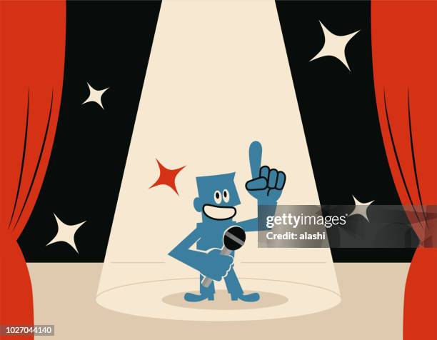 smiling blue man (host) on stage with microphone and spotlight - searchlight stock illustrations