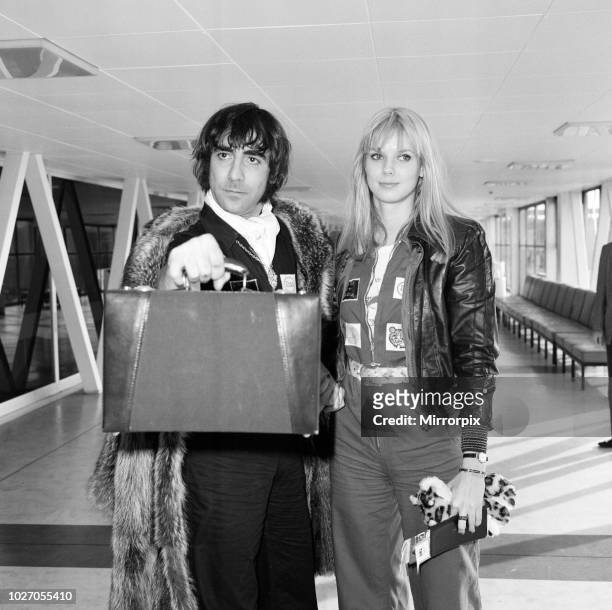 Keith Moon, drummer of The Who rock group, pictured leaving Heathrow Airport for holiday in Los Angeles with girlfriend Annette Walter-Lax. 12th...