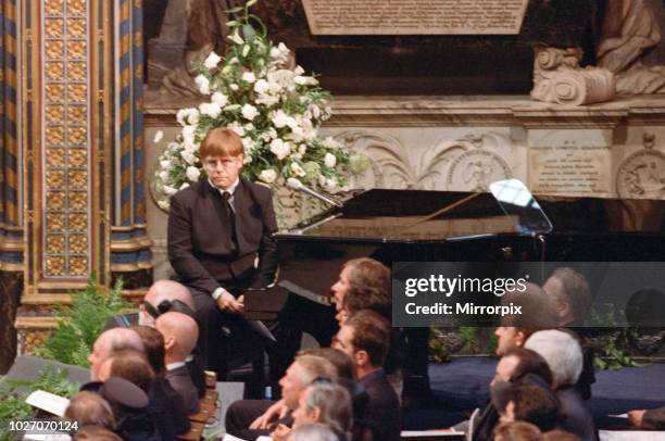 Sir Elton John at the funeral of Diana, Princess of Wales at Westminster Abbey, London. Pictured sitting at the piano where he sang a revised version...