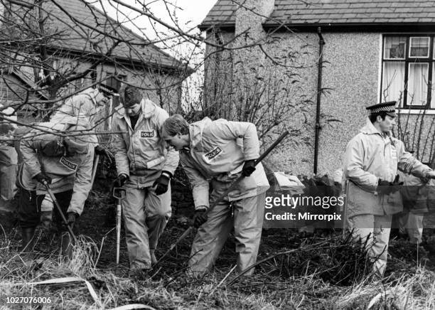 Police searching the ground behind the home of Peter Sutcliffe in Bradford following his arrest. 9th January 1981.