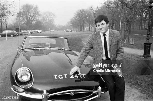 Tony Blackburn, Radio One disc jockey, pictured in Hyde Park, London. He is seen with his new E-Type Jaguar - the registration number is the same as...