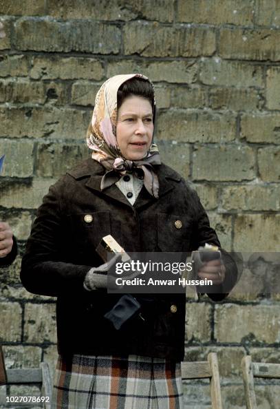 Queen Elizabeth ll holds her her gold Rollei camera during a visit to ...