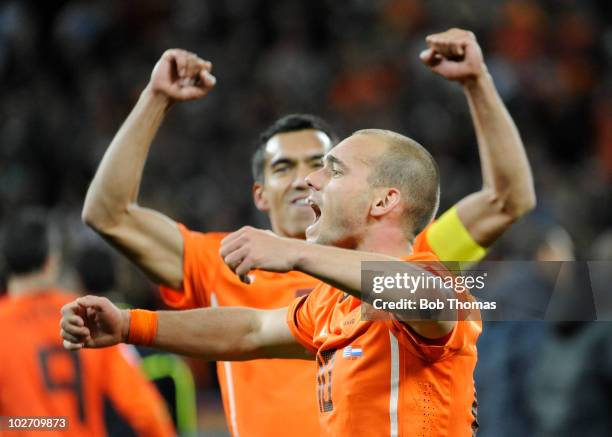 Wesley Sneijder and Giovanni Van Bronckhorst of the Netherlands celebrate victory and progress to the final after the 2010 FIFA World Cup South...